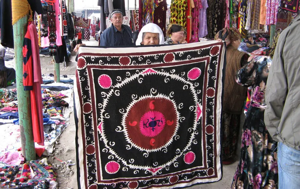 Traders showing suzani at the Urgut bazaar near Samarkand